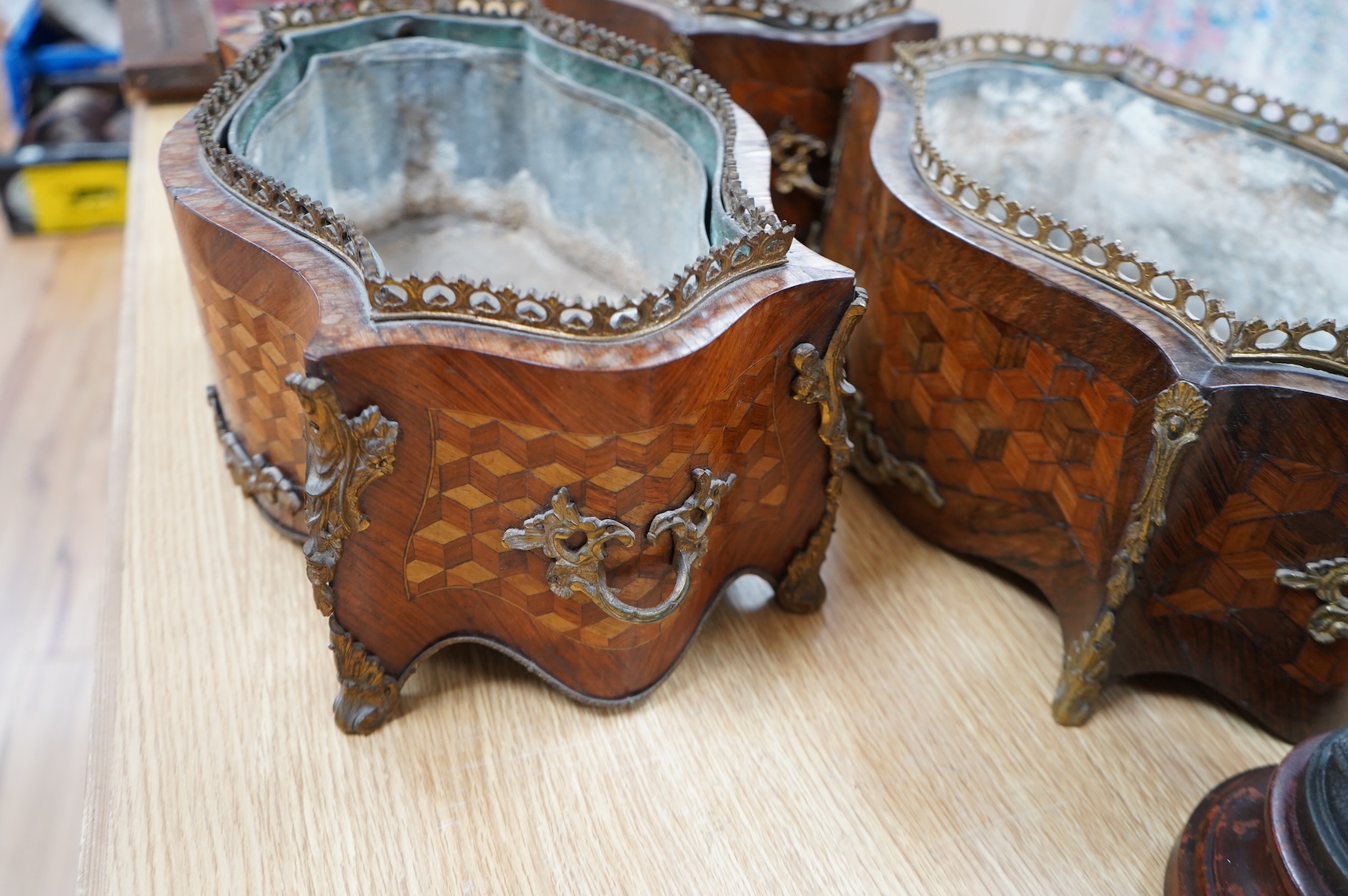 A pair of French Transitional style kingwood and parquetry table jardinières and one other, 43cm wide